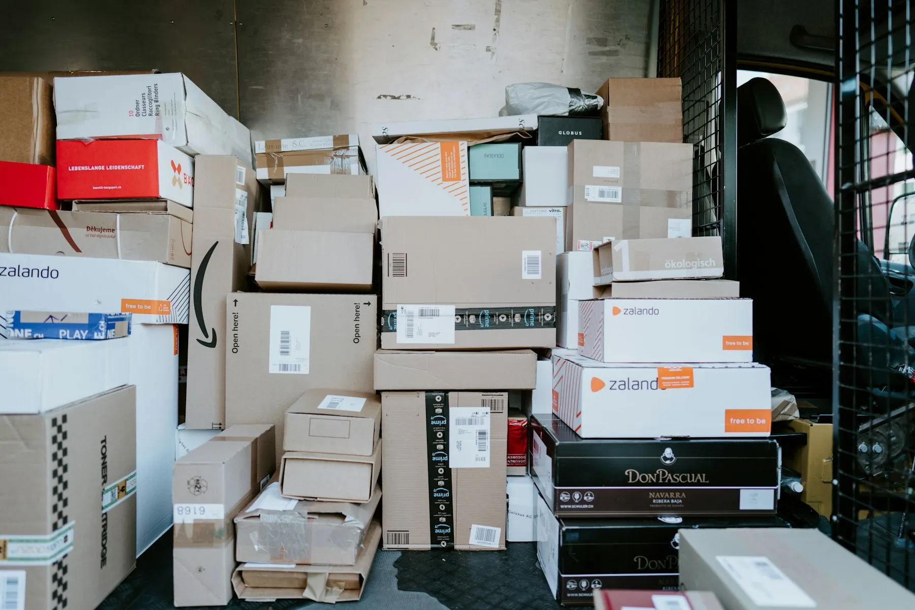 Stack of cardboard shipping boxes inside a delivery van
